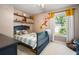 bedroom featuring a dark blue bed, stuffed animals and playful wall decor at 2208 Mountain Springs Nw Ct, Kennesaw, GA 30144