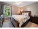 A comfortable bedroom with a plush bed, matching bedside tables, and large window at 2208 Mountain Springs Nw Ct, Kennesaw, GA 30144