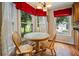 Breakfast nook features round table with chairs surrounded by bay windows overlooking the yard at 2208 Mountain Springs Nw Ct, Kennesaw, GA 30144