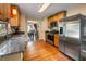 Bright kitchen features wooden cabinetry, stainless steel appliances, granite countertops, and hardwood floors at 2208 Mountain Springs Nw Ct, Kennesaw, GA 30144