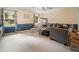 Spacious carpeted living room features a large gray sectional, two windows, and overhead lighting at 2208 Mountain Springs Nw Ct, Kennesaw, GA 30144