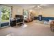 Bright living room with built in desk space, cream carpet, and window letting in lots of natural light at 2208 Mountain Springs Nw Ct, Kennesaw, GA 30144