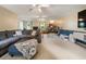 Spacious living room with cozy gray sectional sofa and adjacent play area for children at 2208 Mountain Springs Nw Ct, Kennesaw, GA 30144