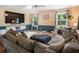 Comfortable living room has a large sectional sofa, wall-mounted TV, and two windows with curtains at 2208 Mountain Springs Nw Ct, Kennesaw, GA 30144