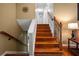 Wooden staircase features iron spindles, wooden handrail, and white trim at 2208 Mountain Springs Nw Ct, Kennesaw, GA 30144