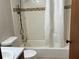 Bathroom features a tub with tiled walls and shower curtain at 2917 Katherine Valley Rd, Decatur, GA 30032