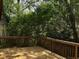 View of the wooden deck surrounded by trees and greenery at 2917 Katherine Valley Rd, Decatur, GA 30032