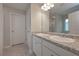 Well-lit bathroom featuring granite counter tops, dual sinks, and a large mirror at 496 Charleston Pl, Villa Rica, GA 30180
