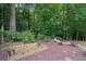 Lush backyard featuring garden beds, mature trees, and a serene landscape for outdoor enjoyment and privacy at 9125 Patrick Pl, Winston, GA 30187