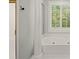 Bright bathroom featuring a standalone shower and a soaking tub with jets at 9125 Patrick Pl, Winston, GA 30187
