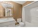 Bathroom with a single sink vanity, framed mirror, tub shower and tan paint at 9125 Patrick Pl, Winston, GA 30187