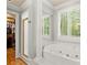 Bright bathroom featuring a standalone shower and a soaking tub with jets at 9125 Patrick Pl, Winston, GA 30187