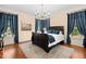 Primary bedroom with hardwood floors, a chandelier and large windows at 9125 Patrick Pl, Winston, GA 30187