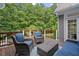 Outdoor deck area featuring outdoor furniture and wooded views at 9125 Patrick Pl, Winston, GA 30187
