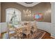 Formal dining room featuring ornate chairs, marble table, and elegant chandelier at 9125 Patrick Pl, Winston, GA 30187