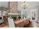 Dining room with stone fireplace and wooden table, open to kitchen and living room at 9125 Patrick Pl, Winston, GA 30187