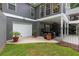 Rear exterior showing a garage and covered outdoor space leading to landscaped backyard at 9125 Patrick Pl, Winston, GA 30187