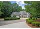 Charming gray home with circular driveway, water feature, and lush landscaping at 9125 Patrick Pl, Winston, GA 30187