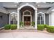 Inviting front entrance with stone accents, double wooden doors, and manicured greenery at 9125 Patrick Pl, Winston, GA 30187