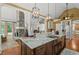 Gourmet kitchen featuring stainless steel appliances, stone fireplace, and a granite countertop island at 9125 Patrick Pl, Winston, GA 30187