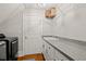 A laundry room featuring a utility sink, plenty of counter space, overhead storage and a washer and dryer set at 9125 Patrick Pl, Winston, GA 30187