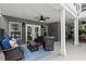 Relaxing outdoor patio featuring comfortable seating, ceiling fans, and a view of the backyard at 9125 Patrick Pl, Winston, GA 30187