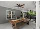 Covered outdoor patio with ceiling fans and an outdoor table perfect for dining al fresco at 9125 Patrick Pl, Winston, GA 30187