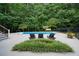 In-ground swimming pool surrounded by lounge chairs and mature trees providing privacy and shade at 9125 Patrick Pl, Winston, GA 30187