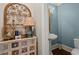 Charming powder room featuring custom cabinet and unique decor at 9125 Patrick Pl, Winston, GA 30187