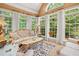 Bright sunroom featuring many windows, ornate furniture, and a beautiful area rug at 9125 Patrick Pl, Winston, GA 30187