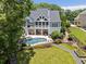 Aerial view of a home showcasing a swimming pool, patio, and landscaping, creating a luxurious outdoor oasis at 2429 Kirk Nw Ln, Kennesaw, GA 30152