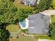 Aerial view of a home with a swimming pool, lush landscaping, and a well-maintained roof at 2429 Kirk Nw Ln, Kennesaw, GA 30152