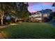 Expansive backyard featuring a manicured lawn, mature trees, and an elegant fence for privacy and seclusion at 2429 Kirk Nw Ln, Kennesaw, GA 30152