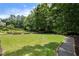Expansive backyard featuring a manicured lawn and raised garden beds, perfect for outdoor enjoyment and gardening at 2429 Kirk Nw Ln, Kennesaw, GA 30152