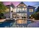 Stunning backyard with a sparkling pool, hot tub, covered patio, and upper balcony, perfect for entertaining at 2429 Kirk Nw Ln, Kennesaw, GA 30152