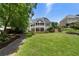 Expansive backyard with a large lawn and a pathway, providing a beautiful outdoor space for relaxation and recreation at 2429 Kirk Nw Ln, Kennesaw, GA 30152