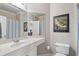 Bathroom with white cabinetry, framed mirror and golf-themed artwork on the wall at 2429 Kirk Nw Ln, Kennesaw, GA 30152