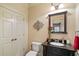 Bathroom with vanity, mirror, toilet, and white closet doors at 2429 Kirk Nw Ln, Kennesaw, GA 30152