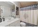 This light-filled bathroom with a shower features a large mirror, vanity, and neutral tile floors at 2429 Kirk Nw Ln, Kennesaw, GA 30152