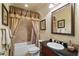 Traditional bathroom with vanity, framed mirror, tub with curtain, and neutral color scheme at 2429 Kirk Nw Ln, Kennesaw, GA 30152