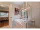 Bathroom showing a soaking tub next to a stained glass window and frameless glass shower at 2429 Kirk Nw Ln, Kennesaw, GA 30152