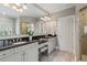 Bright bathroom boasts double vanities, granite countertops, a large mirror, and a glass-enclosed shower at 2429 Kirk Nw Ln, Kennesaw, GA 30152
