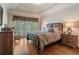 Cozy bedroom showcasing hardwood floors, a window with shuttered blinds, and neutral decor at 2429 Kirk Nw Ln, Kennesaw, GA 30152