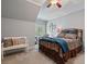 Charming bedroom featuring a decorative metal bed frame, bench, and natural light from a window at 2429 Kirk Nw Ln, Kennesaw, GA 30152