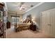 Spacious bedroom with a four-poster bed, ceiling fan, and neutral color palette at 2429 Kirk Nw Ln, Kennesaw, GA 30152