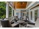 Screened porch with vaulted tongue and groove ceiling and comfortable seating area at 2429 Kirk Nw Ln, Kennesaw, GA 30152
