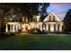 Charming home featuring a well-manicured lawn and cozy front porch, illuminated for nighttime appeal at 2429 Kirk Nw Ln, Kennesaw, GA 30152