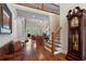 Bright foyer boasts hardwood floors, staircase, and living room access, with an antique clock at 2429 Kirk Nw Ln, Kennesaw, GA 30152