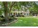 Charming two-story home with a welcoming front porch, lush lawn, and mature landscaping at 2429 Kirk Nw Ln, Kennesaw, GA 30152