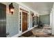 Inviting front porch with stone flooring, rocking chairs, and classic exterior lighting at 2429 Kirk Nw Ln, Kennesaw, GA 30152